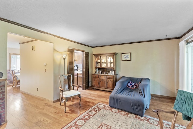8847 Ironwood Ave S, Cottage Grove, MN 55016 - living area featuring light wood-style floors, ornamental molding, and baseboards