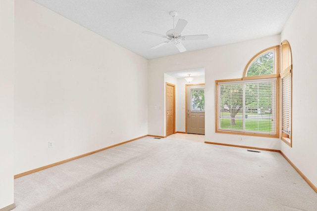 10767 Tamarack Cir NW, Coon Rapids, MN 55433 - unfurnished room with light carpet and a ceiling fan