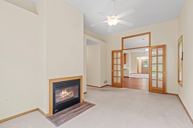 10767 Tamarack Cir NW, Coon Rapids, MN 55433 - unfurnished living room featuring french doors, carpet floors, a fireplace with flush hearth, and ceiling fan