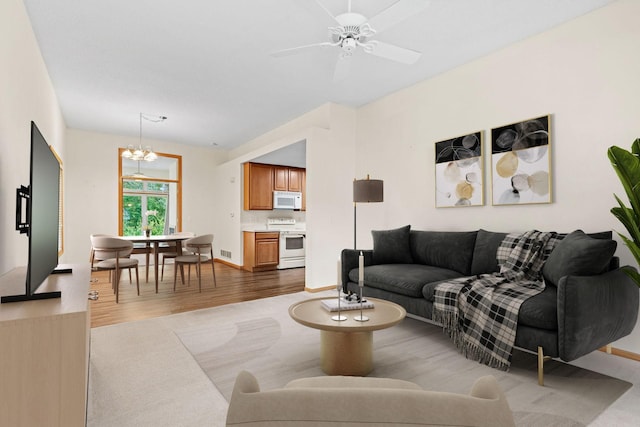 10767 Tamarack Cir NW, Coon Rapids, MN 55433 - living area with a chandelier, wood finished floors, and ceiling fan