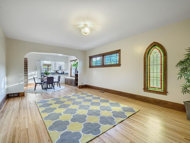 1396 Palace Ave, Saint Paul, MN 55105 - sitting room featuring arched walkways, light wood finished floors, and baseboards