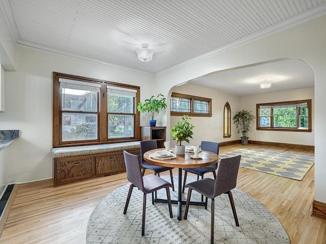 1396 Palace Ave, Saint Paul, MN 55105 - dining space featuring arched walkways, crown molding, and light wood-style floors