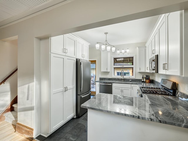 1396 Palace Ave, Saint Paul, MN 55105 - kitchen featuring appliances with stainless steel finishes, a sink, dark stone counters, a chandelier, and white cabinets