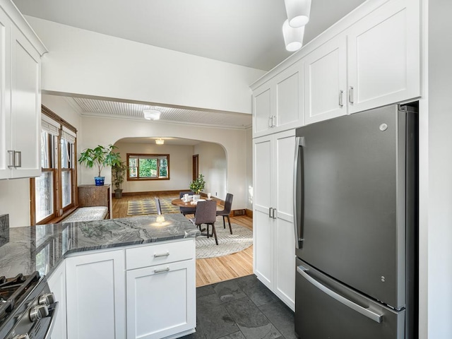 1396 Palace Ave, Saint Paul, MN 55105 - kitchen featuring freestanding refrigerator, arched walkways, white cabinetry, and crown molding