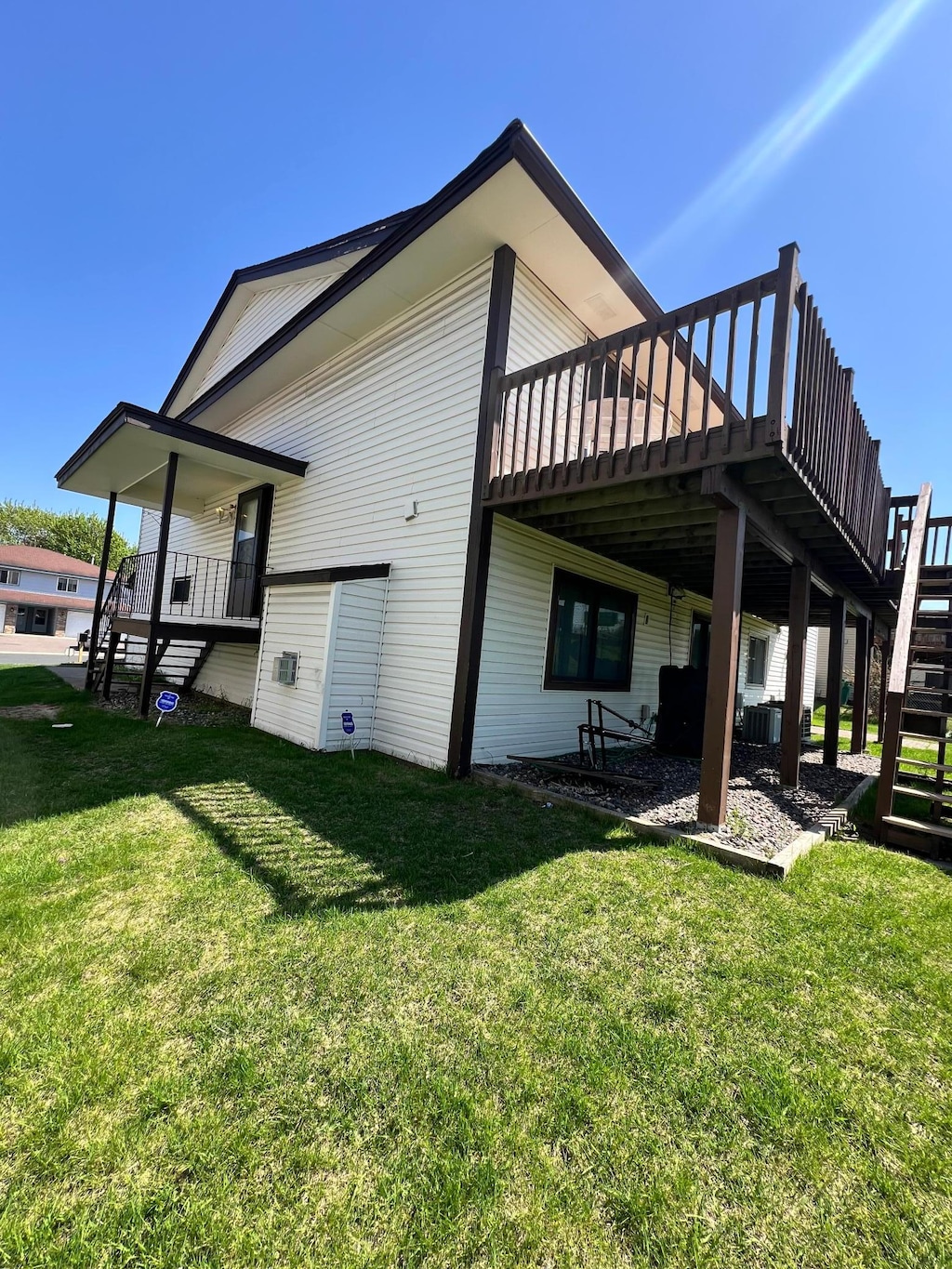 3557 Independence Ave N, New Hope, MN 55427 - rear view of house with stairway, a deck, and a lawn