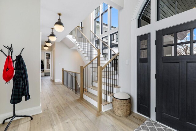 5283 Frost Point Cir SE, Prior Lake, MN 55372 - entrance foyer with stairway, light wood-type flooring, and baseboards