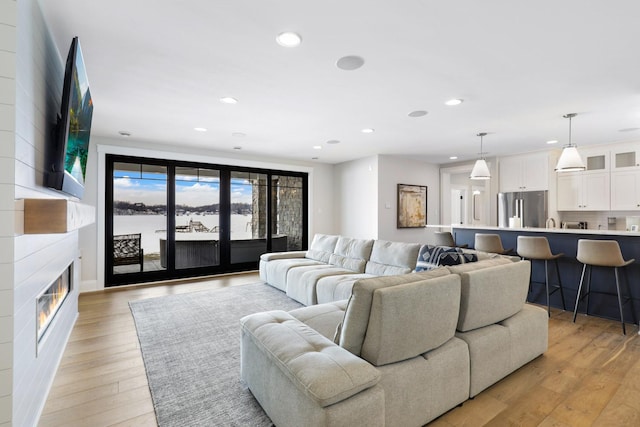 5283 Frost Point Cir SE, Prior Lake, MN 55372 - living area featuring light wood-style floors, recessed lighting, and a fireplace