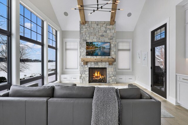 5283 Frost Point Cir SE, Prior Lake, MN 55372 - living room with a chandelier, high vaulted ceiling, a fireplace, light wood finished floors, and baseboards