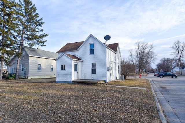 715 8th St E, Thief River Falls, MN 56701 - rear view of property featuring roof with shingles and central air condition unit