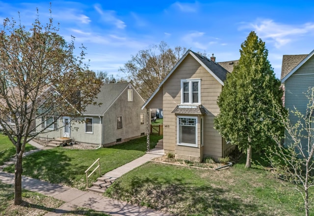 1415 Wynne Ave, Saint Paul, MN 55108 - view of front of house with a front lawn and a shingled roof