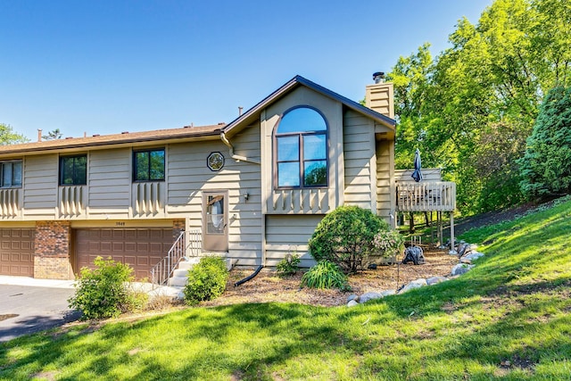 3948 Orchid Ln N, Plymouth, MN 55446 - view of front of property with a chimney, a garage, a front lawn, brick siding, and driveway