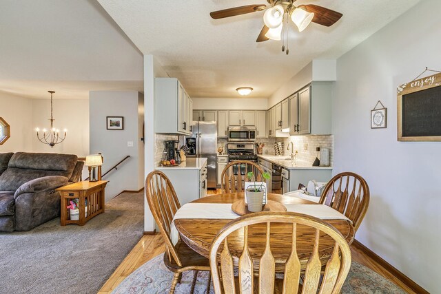 3948 Orchid Ln N, Plymouth, MN 55446 - dining space with ceiling fan, a chandelier, baseboards, and light wood-style flooring