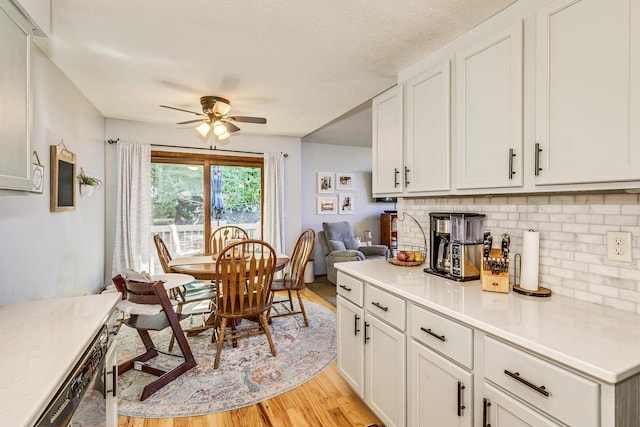 3948 Orchid Ln N, Plymouth, MN 55446 - kitchen featuring light wood-style flooring, ceiling fan, backsplash, light countertops, and white cabinets