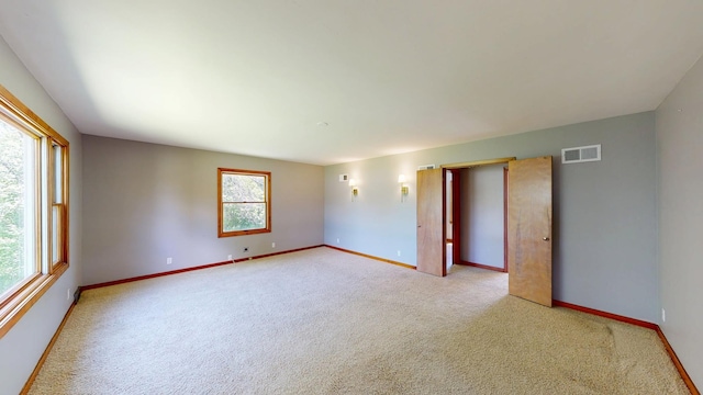 706 19th St, Albert Lea, MN 56007 - empty room with plenty of natural light, baseboards, and light colored carpet
