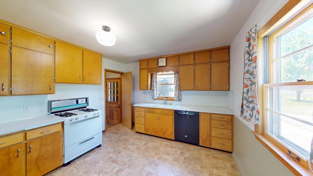 706 19th St, Albert Lea, MN 56007 - kitchen with dishwasher, white range with gas stovetop, a sink, and light countertops
