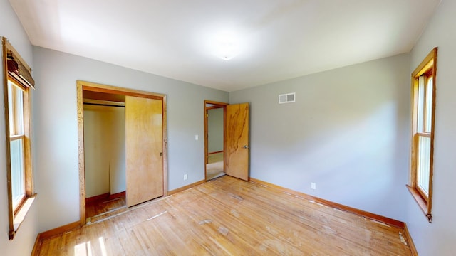 706 19th St, Albert Lea, MN 56007 - unfurnished bedroom with baseboards, light wood-type flooring, and a closet