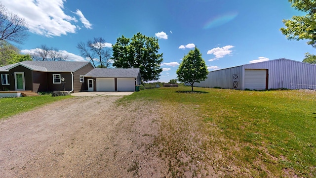 706 19th St, Albert Lea, MN 56007 - view of front of house with driveway, a front yard, and an outbuilding