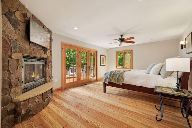4080 Lotus Dr, Minnetrista, MN 55331 - bedroom with access to exterior, wood finished floors, a fireplace, baseboards, and a ceiling fan