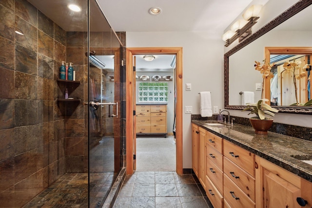 4080 Lotus Dr, Minnetrista, MN 55331 - full bath featuring double vanity, tiled shower, stone tile floors, and recessed lighting