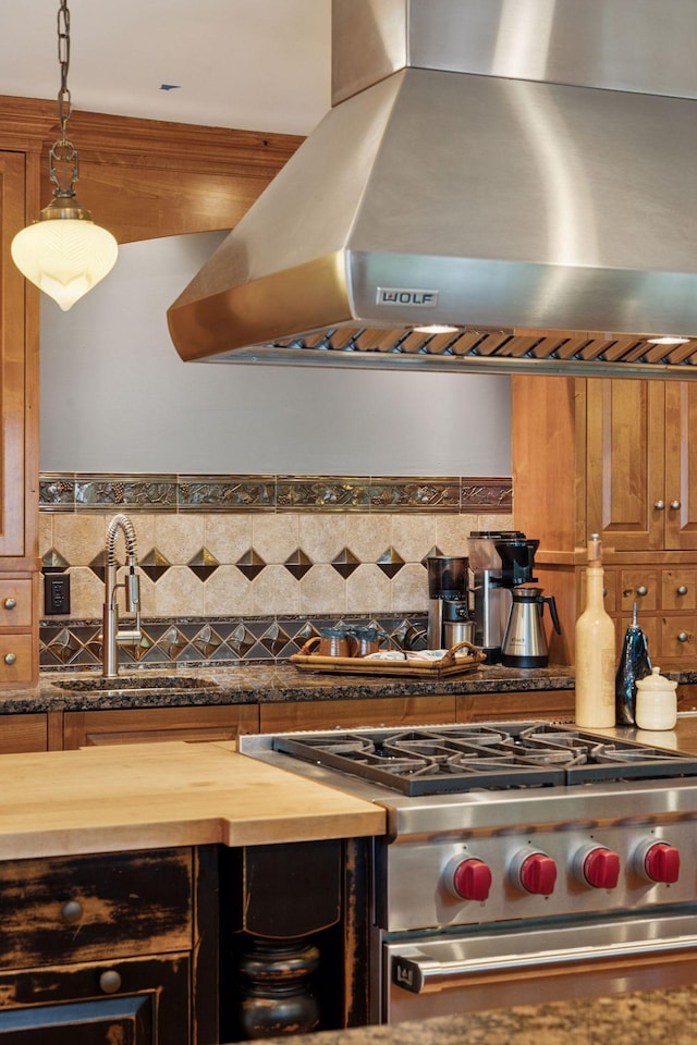 4080 Lotus Dr, Minnetrista, MN 55331 - kitchen featuring wall chimney range hood, high end stainless steel range oven, wood counters, a sink, and decorative backsplash