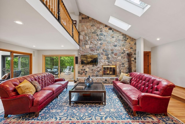 4080 Lotus Dr, Minnetrista, MN 55331 - living room featuring a skylight, recessed lighting, wood finished floors, a fireplace, and high vaulted ceiling