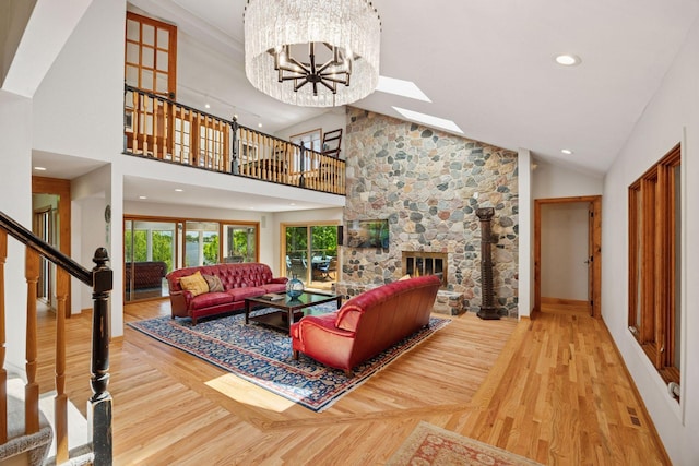 4080 Lotus Dr, Minnetrista, MN 55331 - living area with wood finished floors, stairs, recessed lighting, a stone fireplace, and high vaulted ceiling