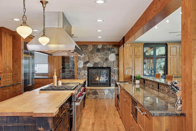 4080 Lotus Dr, Minnetrista, MN 55331 - kitchen featuring wood counters, premium appliances, island exhaust hood, a spacious island, and recessed lighting