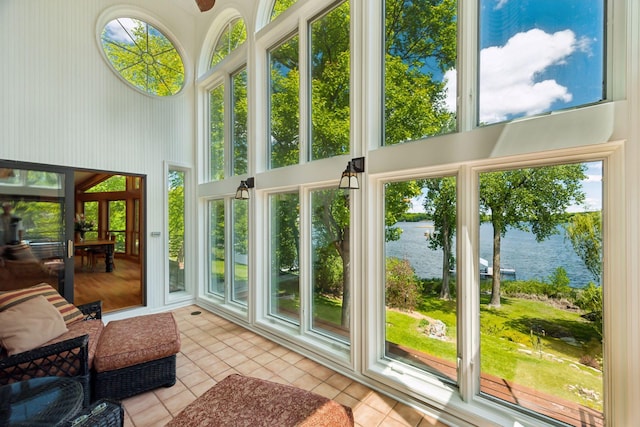 4080 Lotus Dr, Minnetrista, MN 55331 - sunroom / solarium featuring a water view, tile patterned flooring, and a towering ceiling