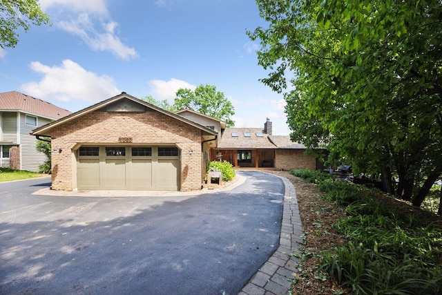 4080 Lotus Dr, Minnetrista, MN 55331 - ranch-style home with brick siding, a chimney, and a garage