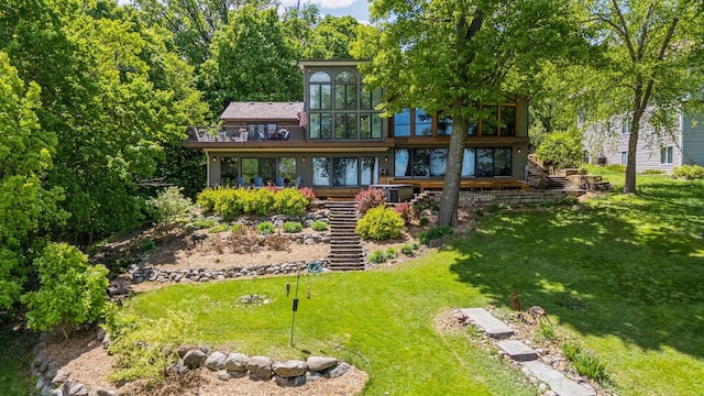 4080 Lotus Dr, Minnetrista, MN 55331 - back of property with stairs, a yard, and a balcony