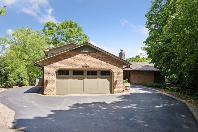4080 Lotus Dr, Minnetrista, MN 55331 - view of front of house featuring brick siding and a chimney