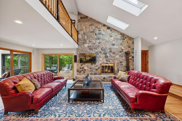 4080 Lotus Dr, Minnetrista, MN 55331 - living area featuring a skylight, wood finished floors, recessed lighting, a stone fireplace, and high vaulted ceiling