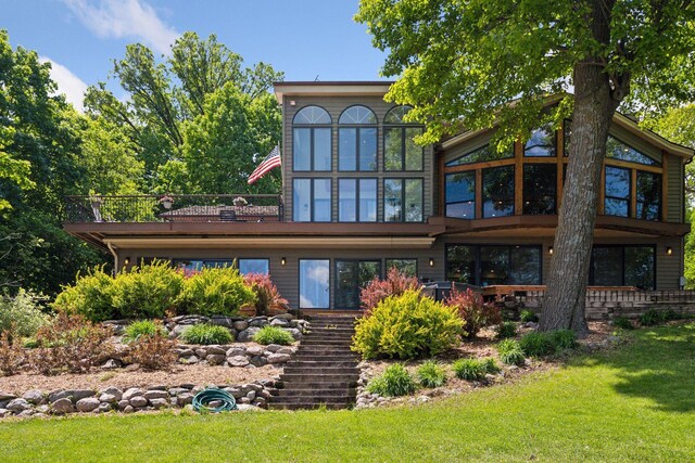 4080 Lotus Dr, Minnetrista, MN 55331 - rear view of house featuring a yard, stairs, and a sunroom