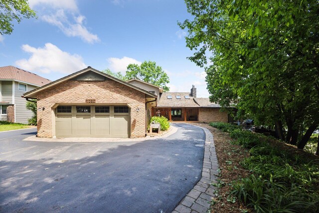 4080 Lotus Dr, Minnetrista, MN 55331 - single story home with brick siding, a chimney, and a garage