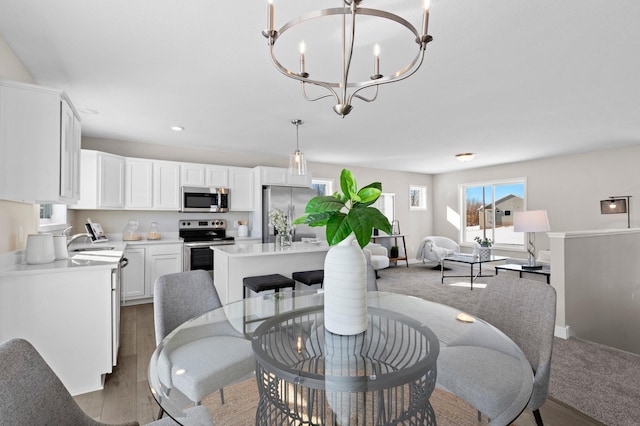 2135 Violet Ln, Faribault, MN 55021 - dining space with a chandelier, recessed lighting, wood finished floors, and baseboards