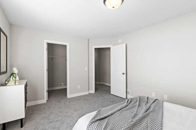 2135 Violet Ln, Faribault, MN 55021 - bedroom featuring carpet flooring, a walk in closet, baseboards, and a closet