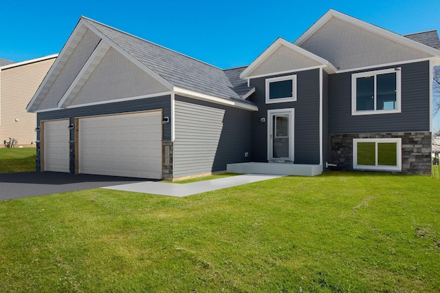 2135 Violet Ln, Faribault, MN 55021 - craftsman-style home featuring stone siding, a front lawn, a garage, asphalt driveway, and roof with shingles