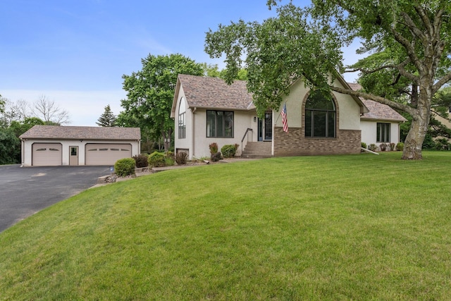 1901 Lexington Ave S, Mendota Heights, MN 55118 - view of front of property with a front yard, an outdoor structure, asphalt driveway, and stucco siding