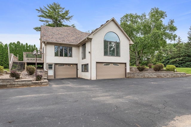 1901 Lexington Ave S, Mendota Heights, MN 55118 - view of front of house featuring a garage, stucco siding, driveway, and stairway