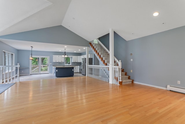 1901 Lexington Ave S, Mendota Heights, MN 55118 - unfurnished living room with stairs, light wood-type flooring, a chandelier, high vaulted ceiling, and recessed lighting