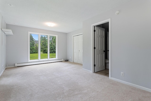 1901 Lexington Ave S, Mendota Heights, MN 55118 - unfurnished bedroom with a baseboard radiator, carpet floors, baseboards, ensuite bath, and a closet