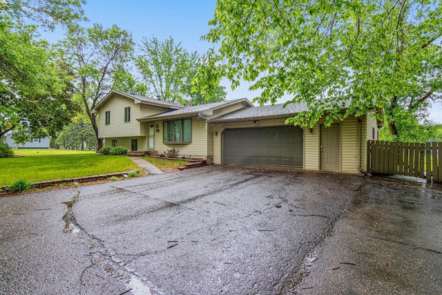11508 Georgia Ave N, Champlin, MN 55316 - split level home with driveway, an attached garage, and a shingled roof