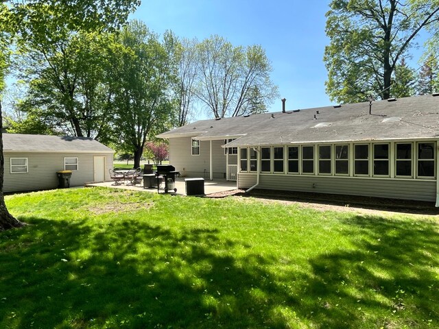 10306 Hemlock St NW, Annandale, MN 55302 - back of house with a patio and a lawn