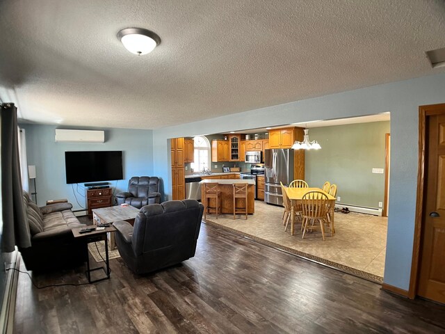 10306 Hemlock St NW, Annandale, MN 55302 - living room featuring a wall unit AC, a textured ceiling, a baseboard radiator, wood finished floors, and a chandelier