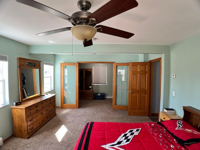 10306 Hemlock St NW, Annandale, MN 55302 - bedroom with carpet flooring, a ceiling fan, and a baseboard heating unit