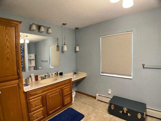 10306 Hemlock St NW, Annandale, MN 55302 - full bathroom featuring baseboard heating, vanity, a textured ceiling, tile patterned flooring, and baseboards