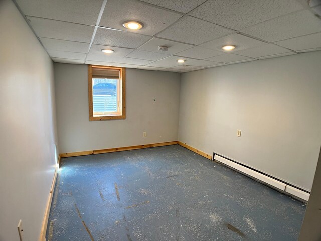 10306 Hemlock St NW, Annandale, MN 55302 - empty room with baseboards, a baseboard heating unit, a drop ceiling, a smoke detector, and concrete flooring