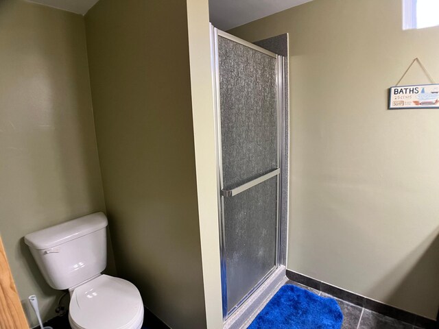 10306 Hemlock St NW, Annandale, MN 55302 - bathroom featuring toilet, a shower stall, and tile patterned floors