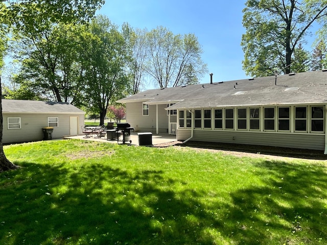 10306 Hemlock St NW, Annandale, MN 55302 - back of house with a patio, a lawn, and a shingled roof