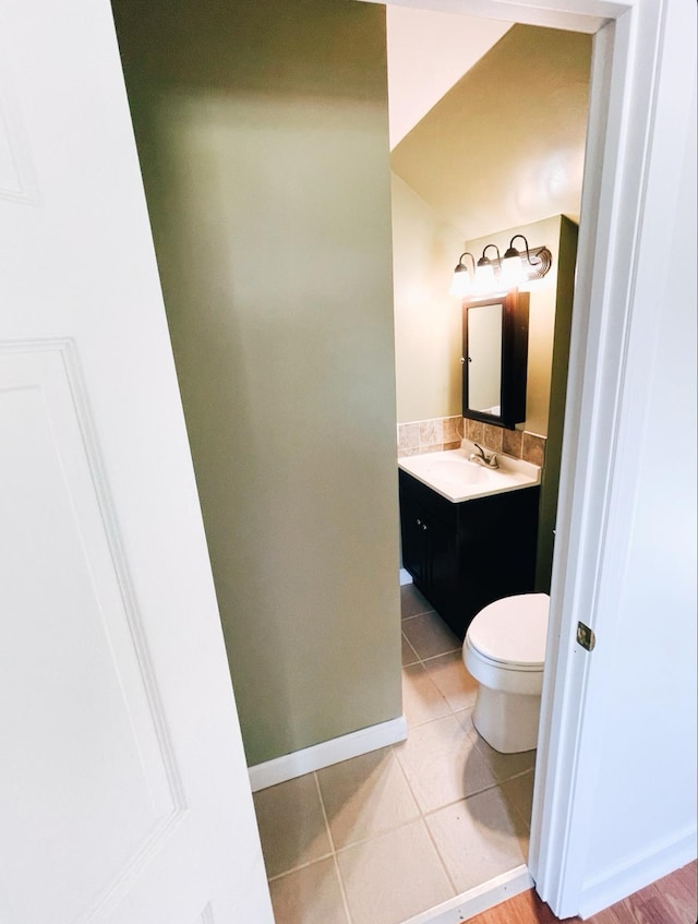415 Francis St, Faribault, MN 55021 - half bathroom featuring vanity, toilet, tile patterned flooring, and baseboards